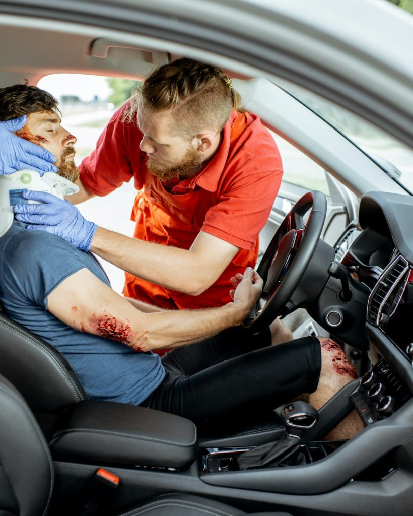 Medics providing emergency medical assistance after the road accident